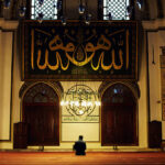 Young muslim man praying in the Great Mosque