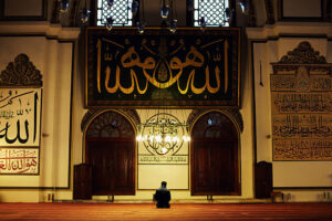 Young muslim man praying in the Great Mosque